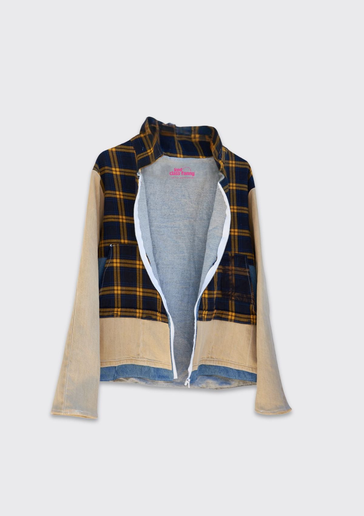 Jacket made from upcycled plaid and denim with beige denim sleeves on a hanger against a white background