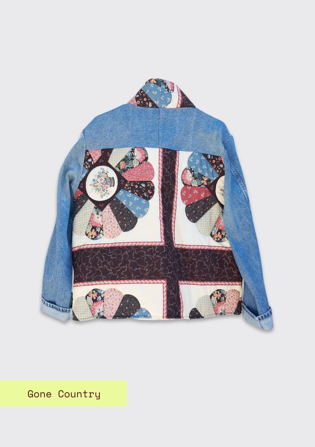 Denim jacket with a colorful quilted design made from upcycled denim jeans and a quilt on a white background.