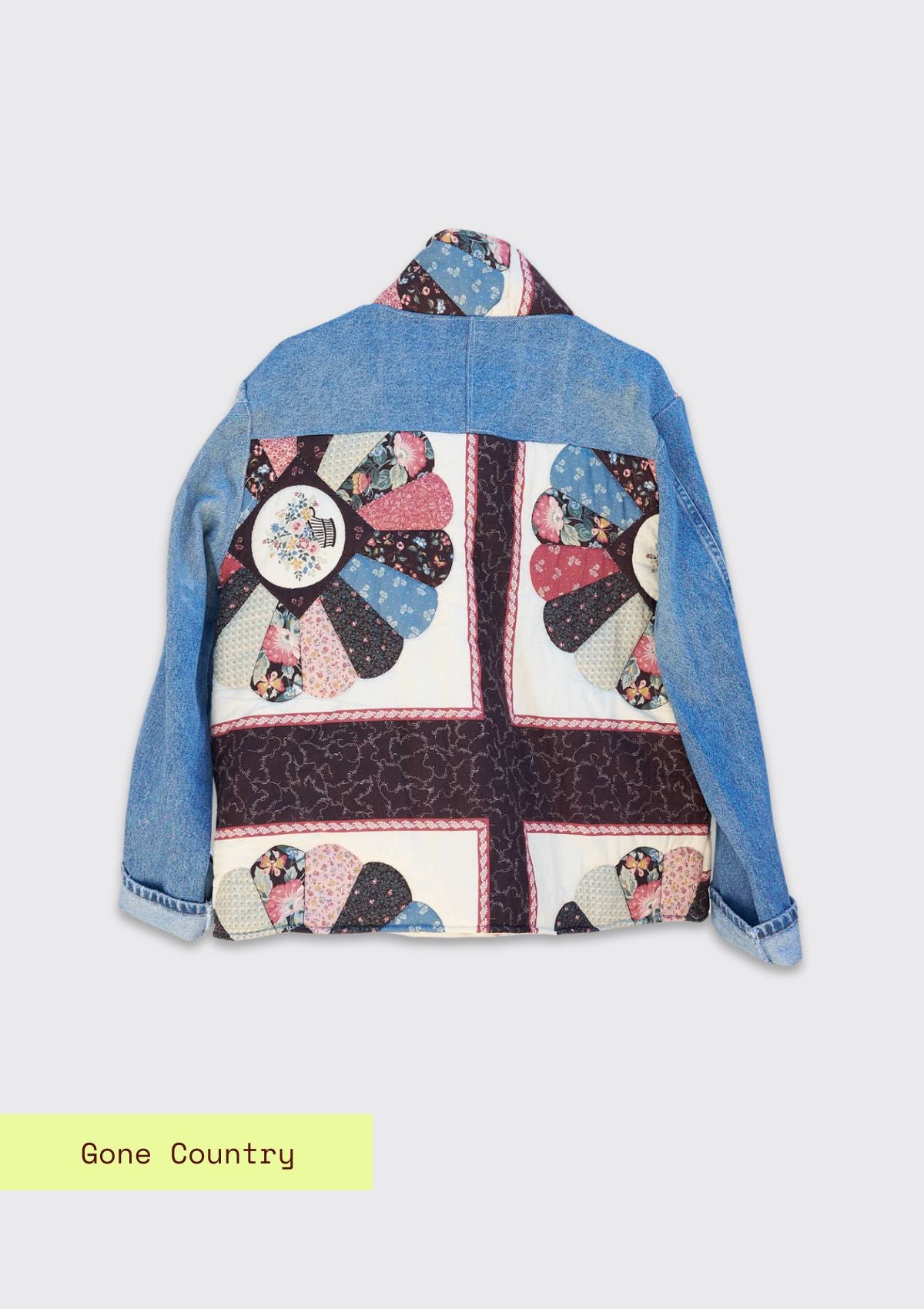 Denim jacket with a colorful quilted design made from upcycled denim jeans and a quilt on a white background.