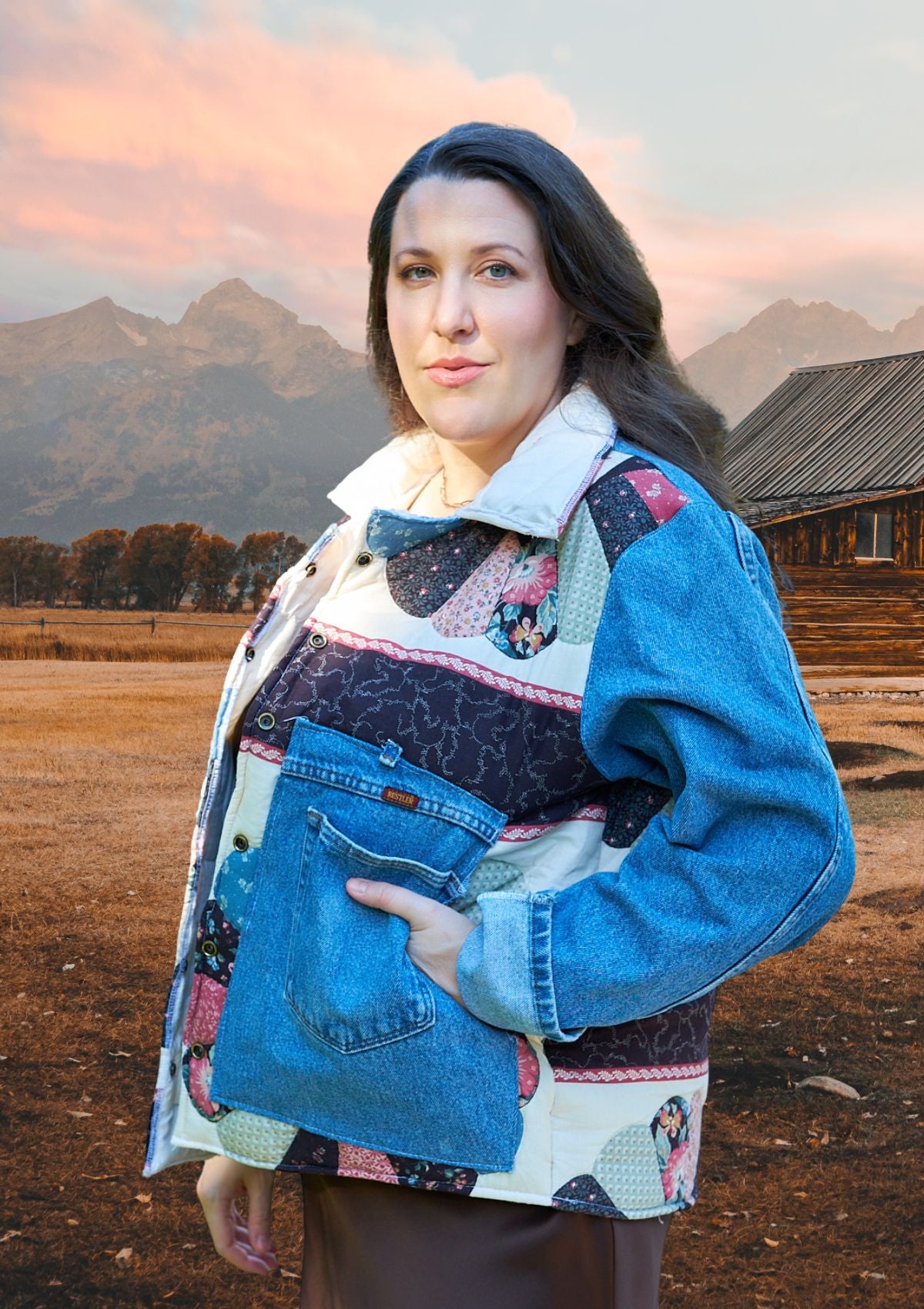 Woman wearing a colorful upcycled denim and quilt patchwork jacket with a mountainous landscape in the background.