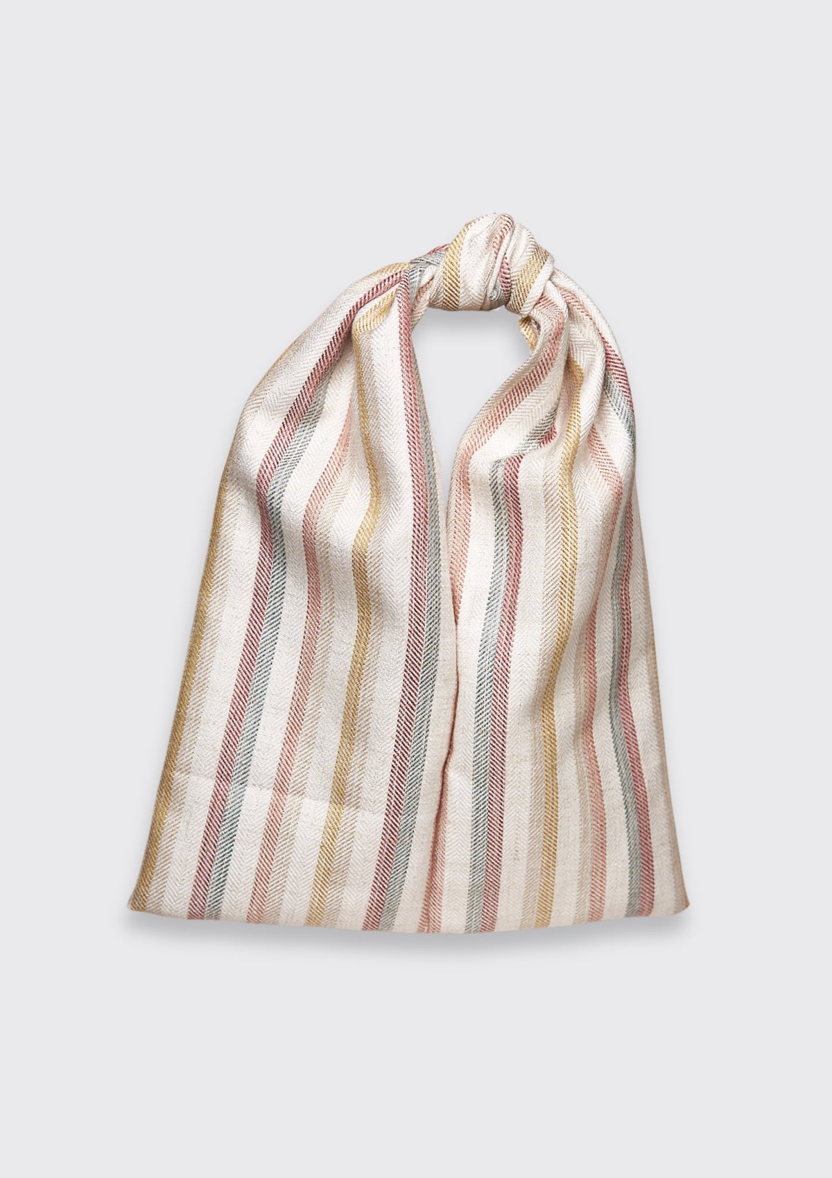 Striped bag tied in a knot upcycled form designer deadstock fabric on a light gray background