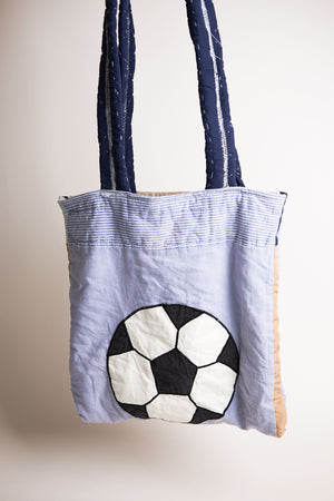 Tote bag with soccer ball design upcycled quilt on a plain background