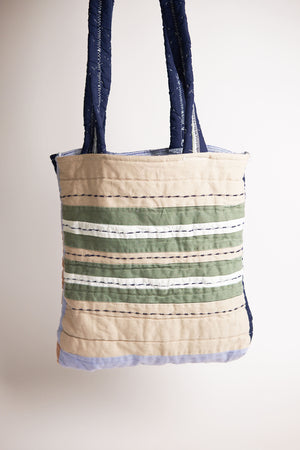 Tote bag with striped pattern upcycled from a quilt on a plain background