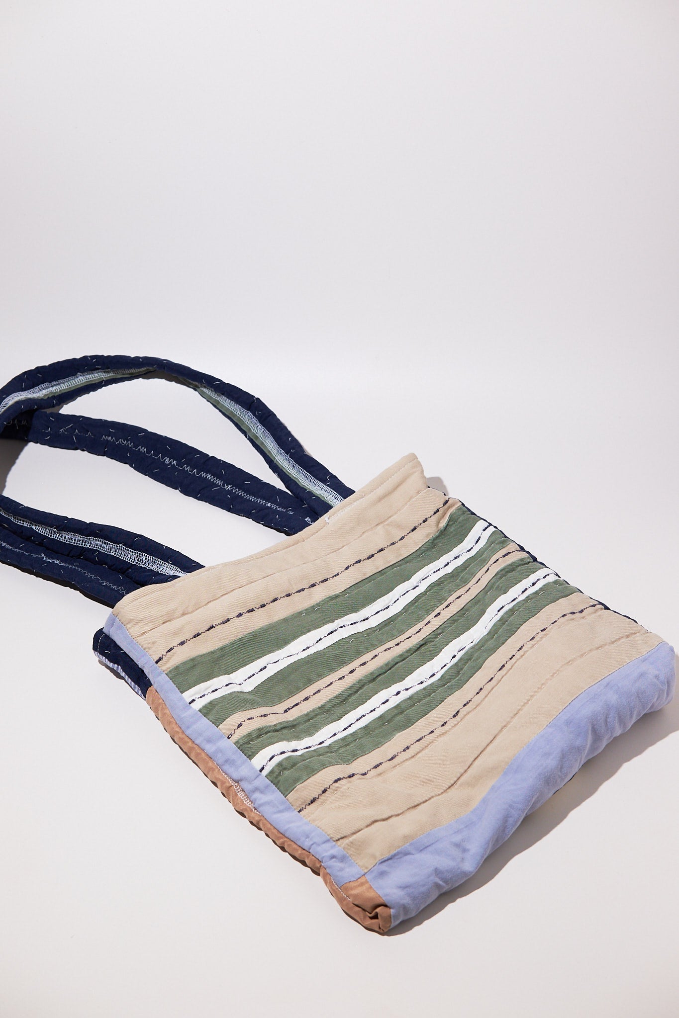 Tote bag made of upcycled qulit with striped pattern on a white background