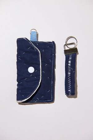 Navy blue wallet with keychain upcycled from comforter on a white background