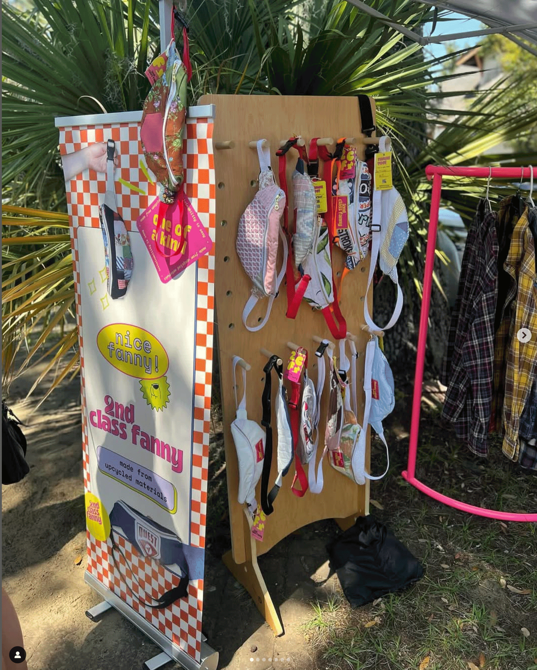 Display of fanny packs and a sign that reads 2nd Class Fanny, made from upcycled materials