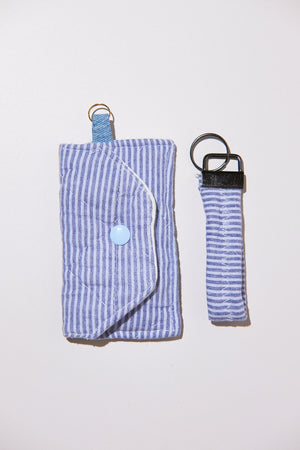 Blue striped pouch and matching keychain upcycled from comforter on a white background